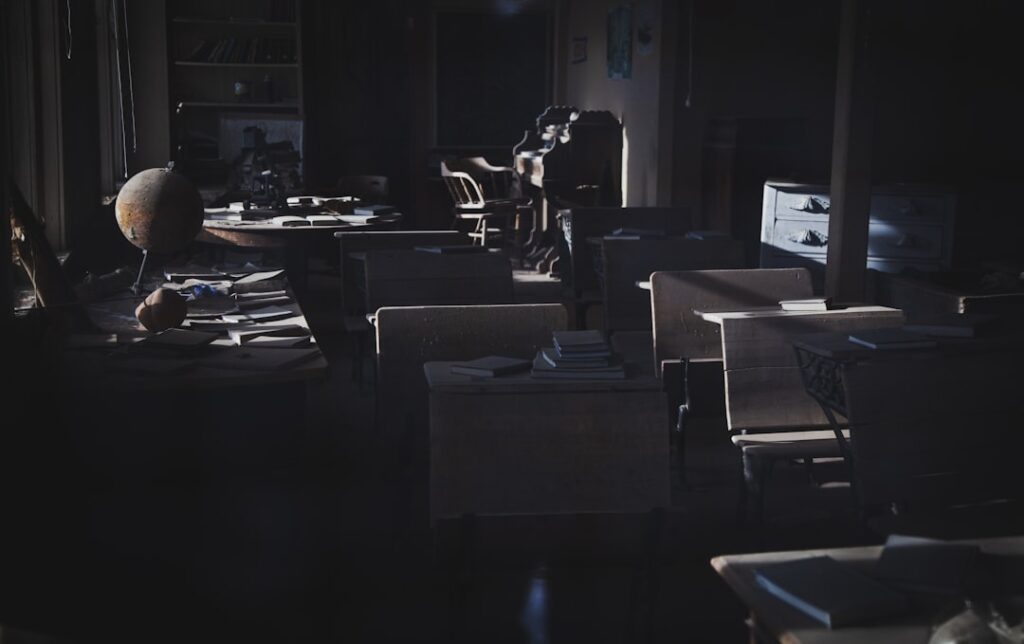 Real estate professional looks overwhelmed by a large stack of papers and bills at their modern office desk, symbolizing f...