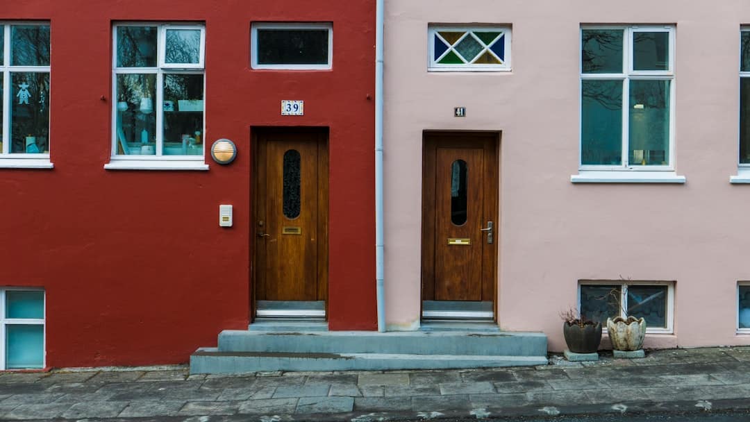 A confident and professionally dressed real estate agent is seen closing the front door of a modern home, symbolizing a successful business transaction.