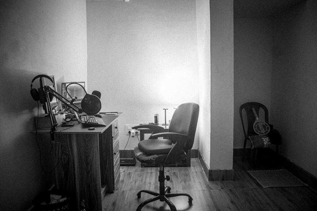 Cluttered and messy office desk with a tangled mess of computer cables and old equipment, symbolizing business inefficienc...