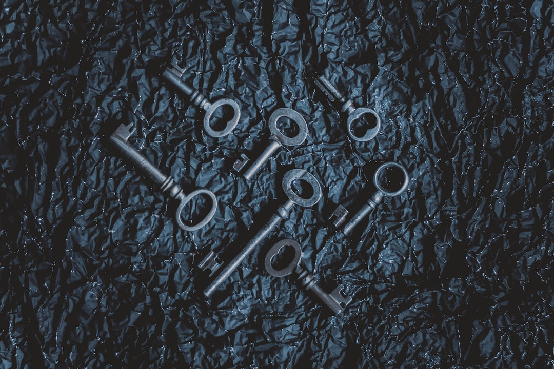An old, heavy, ornate key lies next to a simple, sleek, modern key on a clean background, illustrating the choice between a legacy brokerage and a modern alternative.