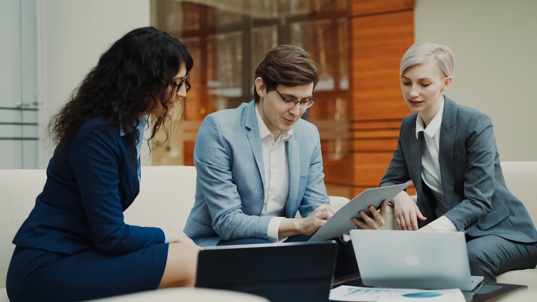 A professional and well-dressed real estate agent sitting at a modern desk, signing a contract, symbolizing the start of a new franchise business.