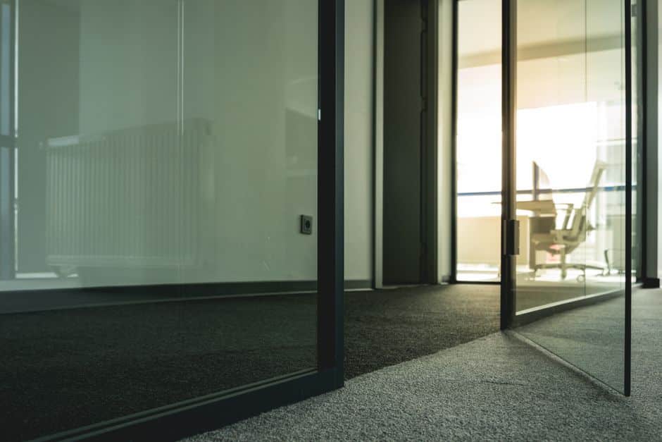 A bright and minimal modern office interior with clean lines, representing the efficiency and low overhead of the lean brokerage business model.