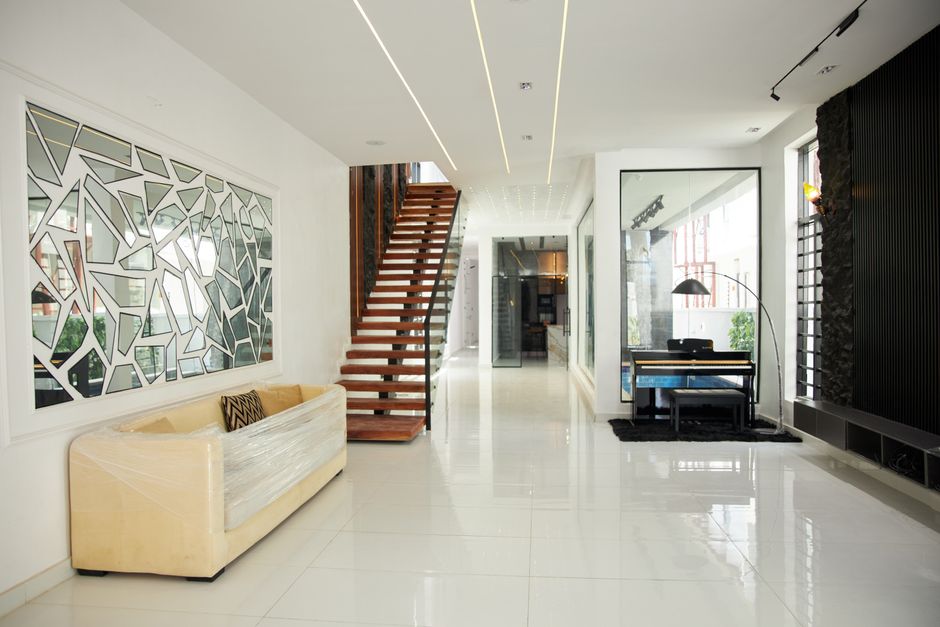 The sunlit interior of a professionally designed modern luxury home with clean lines, showing that true value comes from efficiency and design, not high fees.