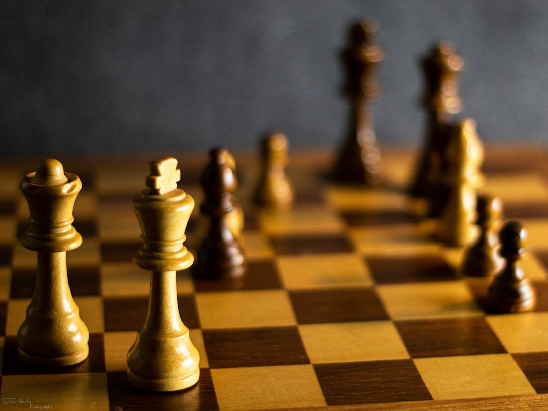 A single chess piece making a strategic move on a minimalist board, symbolizing a smart approach to the real estate price war.