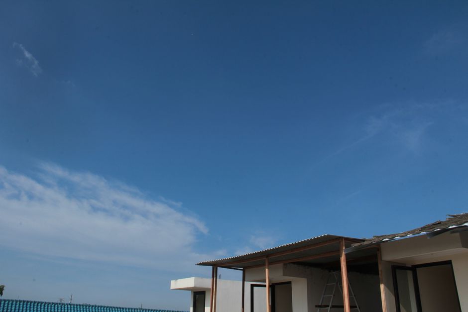 A stunning, minimalist modern home standing alone in a wide, open landscape under a clear sky, illustrating the concept of creating a unique, uncontested space in the real estate market.