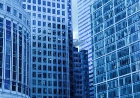Clean, modern real estate office space with desks and computers.