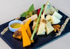 Modern, minimal photograph of a classic mousetrap baited with a piece of cheese, symbolizing the tempting but costly 'free...