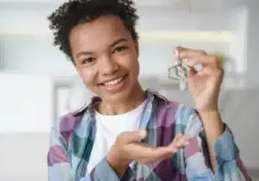 Person holding keys to new house