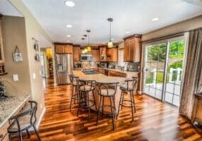 Professionally dressed person's reflection is seen in a shattered or fragmented mirror, symbolizing the deconstruction of ...