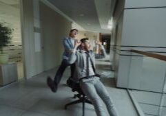 Successful real estate agent in a business suit runs on a treadmill inside a modern office, symbolizing the feeling of wor...